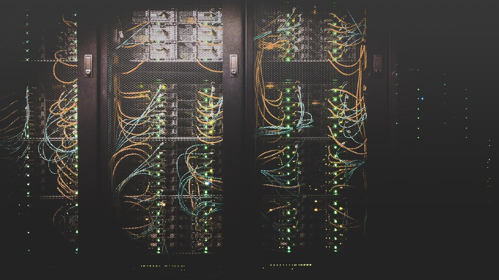 Rows of server racks glowing blue inside a datacenter